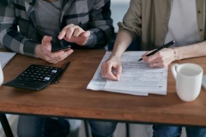 Photo by Mikhail Nilov: https://www.pexels.com/photo/two-people-doing-paperwork-and-computing-taxes-6963053/