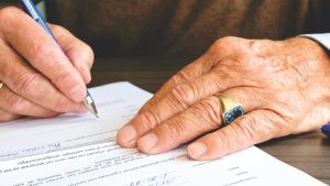 Photo by Matthias Zomer: https://www.pexels.com/photo/person-signing-document-paper-618158/